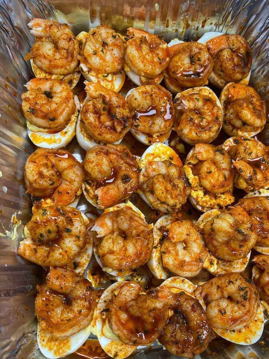 Cajun Shrimp Deviled Eggs: A Flavorful Twist on a Classic Favorite Indulge in a tantalizing fusion of flavors with our Cajun Shrimp Deviled Eggs recipe. Perfect for parties, brunches, or as a delightful appetizer, these deviled eggs are sure to impress even the most discerning palates. With a zesty Cajun twist and succulent shrimp topping, each bite is a culinary delight that will leave you craving more.  History Deviled eggs, also known as stuffed eggs, have a rich culinary history dating back centuries. Originating in ancient Rome, this beloved dish has evolved over time to become a staple in households and restaurants worldwide. Traditionally made with hard-boiled eggs, mayonnaise, and mustard, deviled eggs are often served as hors d’oeuvres or side dishes at social gatherings and holiday feasts. Our Cajun Shrimp Deviled Eggs recipe pays homage to this timeless classic while adding a modern twist with the bold flavors of Cajun seasoning and succulent shrimp.  For Ingredients And Complete Cooking Instructions Please Head On Over To Next Page Or Open button (>) and don’t forget to SHARE with your Facebook friends