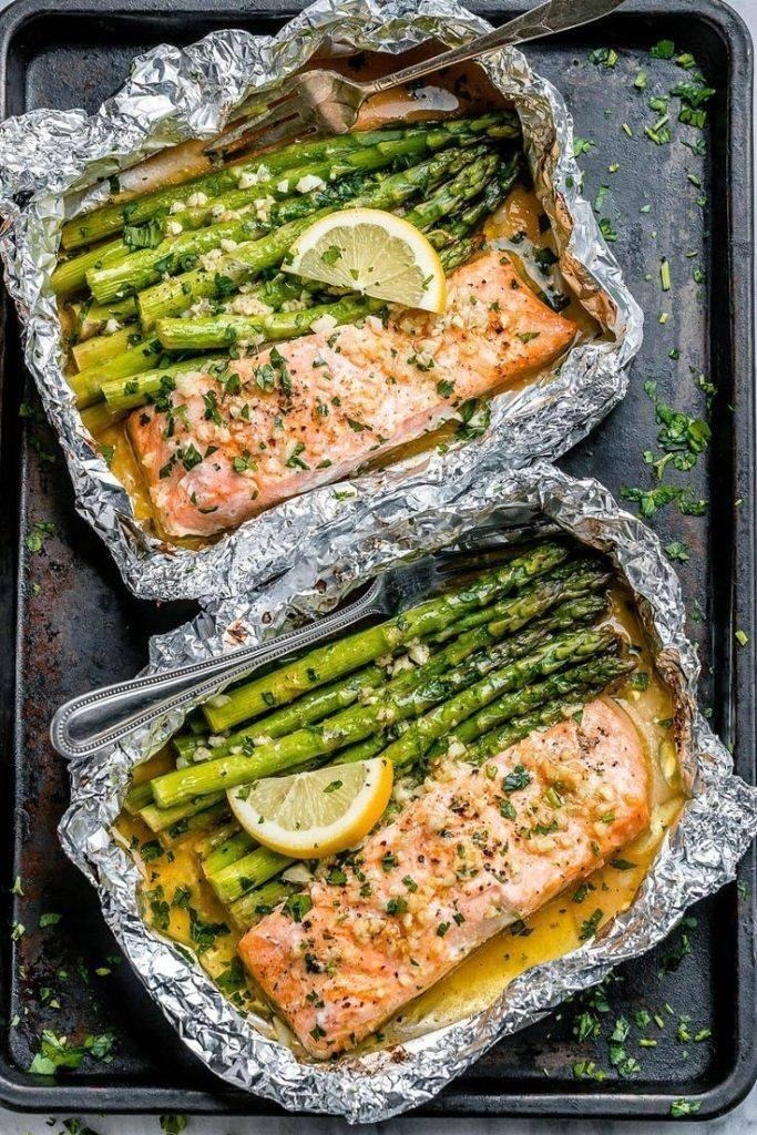 Baked salmon in foil with asparagus and lemon garlic butter sauce